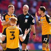 DESPAIR: Mickey Demetriou (left) and County protest after Bobby Madley's controversial penalty call against Morecambe in 2021