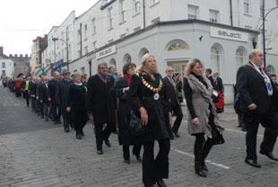 Civic dignitaries march towards the Cenotaph at Chepstow on Sunday