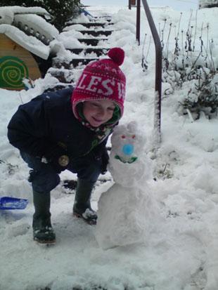 Kallum with his snow man he built on his own. Louise Gay from Risca. 