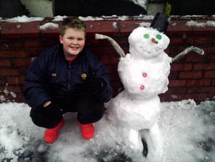 This is Owen Stone aged 11 with his snowman in Newport.