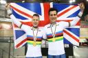 WORLD GLORY: James Ball, left, and pilot Lewis Stewart show off their gold medals. Picture: British Cycling