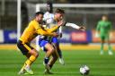TUSSLE: County's Aaron Wildig battles with Colchester's Noah Chilvers at Rodney Parade