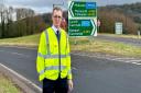 David Davies MP with the mistranslated road sign on the A449 Usk interchange.