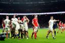 DESPAIR: Aaron Wainwright is dejected as England celebrate their win over Wales
