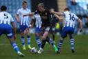 TUSSLE: Harry Charsley is crowded out for County at Colchester