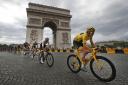 Tour de France winner Britain's Geraint Thomas, wearing the overall leader's yellow jersey, passes the Arc de Triomphe during the twenty-first stage of the Tour de France cycling race over 116 kilometers (72.1 miles) with start in Houilles and fin
