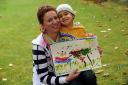 Little Mateusz Popielski and his mum Olga with his painting of the ship
