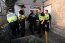 DAWN RAID: Officers storming a suspected drugs den