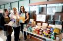 Argus writers Hayley Mills, (lt) and Ruth Mansfield are seen officially handing over the food to Jen Taylor, (centre), of the Eastern Valley Foodbank, which was generously donated by staff at the company (4325639)