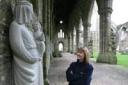 Cadw custodian Hayley Thomas Hill with the statue of Mary and the Child at Tintern Abbey