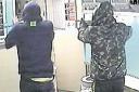 CAUGHT ON CCTV: Armed robbers threaten staff at Ladbrokes betting shop, Commercial Road, Pontllanfraith in this image released by Gwent Police