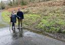 Independent councillor for Ynysddu Jan Jones and amateur chemical pollution investigator Revd Paul Cawthorne look at water flowing from the Ty Llwyd Quarry in Ynysddu, near Caerphilly.