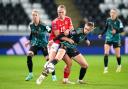 TUSSLE: Wales' Elise Hughes (centre) and Germany's Jule Brand battle for the ball