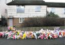 SCENES: Floral tributes outside Nikitta Grender’s boarded-up flat