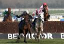 ON WAY TO VICTORY: Eventual winner O'Faolains Boy (centre left) ridden by Barry Geraghty competes with Smad Place ridden by Robert Thornton during the RSA Chase during Champion Day at Cheltenham yesterday