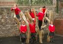 Pupils play on the climbing frame in the school playground.