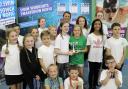 WINNERS: Liz Johnson presents the trophy to Charles Williams' second team of swimmers