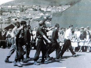 Miners walking towards Six Bells pit on the day of the disaster as crowds look on.
