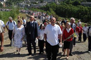 CROWDS walk up the hill to the Six Bells memorial