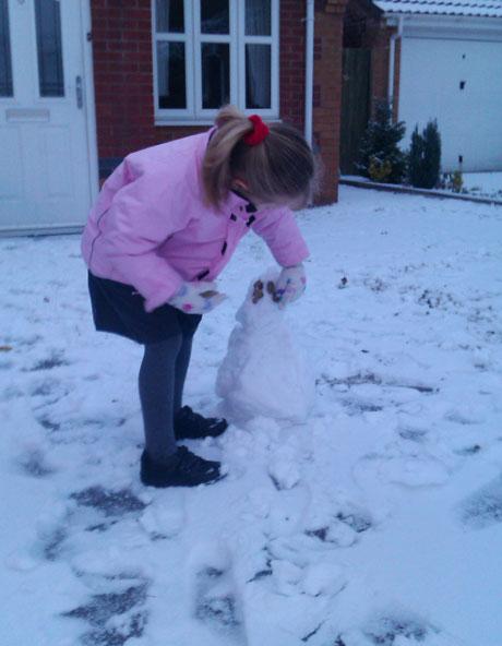 My 4 year old daughter Kiara making a little snowman in Monmouth this morning before going to school. From Simone Teunissen, Monmouth.
