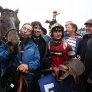 Jack Tudor celebrates his victory on Potters Corner in the Coral Welsh Grand National Handicap Chase with trainer Christian Williams at Chepstow Racecourse. PA Photo. Picture date: Friday December 27, 2019. See PA story RACING Chepstow. Photo credit