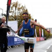 Adam Bowden crosses the line to win the men's ABP Newport Wales marathon. Picture: Huw Evans Picture Agency