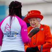 The Queen passing the baton to Kadeena Cox to start the Birmingham 2022 Queen's Baton Relay.