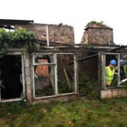 WORK STARTS:  A demolition worker surveys Bulmore farmhouse