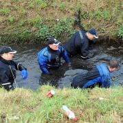 HUNT GOES ON: Police search the reen in Broadmead Park