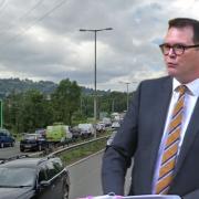 Deputy minister Lee Waters and (background) the A4042 in Pontypool.