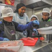 Children take part in cooking sessions run by Steps4Change at Butetown Pavilion in Cardiff.