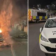 A car set alight and a damaged police car in Ely, Cardiff, as rioters clashed with police.
