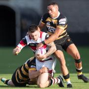 Pontypool goes to ground in tackle from Newport.