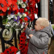Joseph Harris, 2, of Pantygasseg  puts a poppy on the Memorial gates in Pontypool. His poppy a tribute to both his great-grandfathers who were in the Forces.