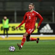 Newport County defender Matt Baker on the ball for Wales U21s