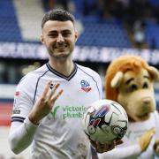 HAT-TRICK: Aaron Collins with the match ball after scoring three times for Bolton against Reading