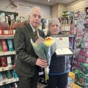 Lynn Hobbs (pictured with Post Office Area Manager Ceri James) has retired after 40 years as the local convenience store owner