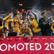 UP: Mansfield celebrate sealing promotion with victory against Accrington