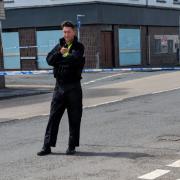 Police officer guards the corned off area on Chepstow Road