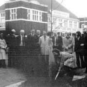 OLD PHOTOGRAPH: Mrs G Lysaght plants a tree outside the Lysaghts Institute back in the early 1970s watched by factory employees