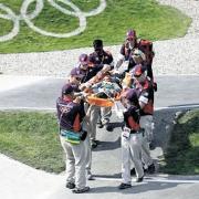 OLYMPIC DUTY: Nurse Jess Arthurs, circled, and her medical colleagues stretcher off a BMX rider injured in one of the heats