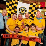 Newport County fans get in the mood for Sunday's trip to Wembley at the Riverside Tavern on Clarence Place with Landlord Mike Jones (front left)
