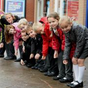 Placing coins on a 200 yard trail in Newport Road, Caldicot, are pupils of Castle Park Primary School, it was all in a good cause to raise funds for St David's Hospice.