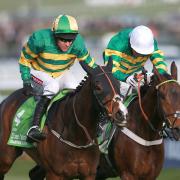 GREAT PERFORMANCE: Jezki, ridden by Barry Geraghty, on their way to winning the Stan James Champion Hurdle Challenge Trophy from My Tent Or Yours ridden by Tony McCoy (right) during Champion Day at Cheltenham Racecourse yesterday
