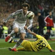 Real Madrid's Gareth Bale, left, takes control of the ball from Villarrealâs Jaume Costa, right, during a Spanish La Liga soccer match between Real Madrid and Villarreal at the Santiago Bernabeu stadium in Madrid, Spain, Sunday, March 1, 2015. (AP