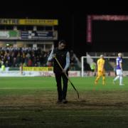 A member of the Rodney Parade groundstaff works on the pitch during a stop in play. (4127183)