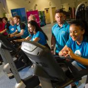 Staff members take part in The Gym 125 mile static bike challenge