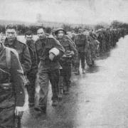 DEFEATED: a Long line of captured British soldiers are led away from Calais during the fall of France. They would later be held in the same prison camps as the soldiers from Gwent.