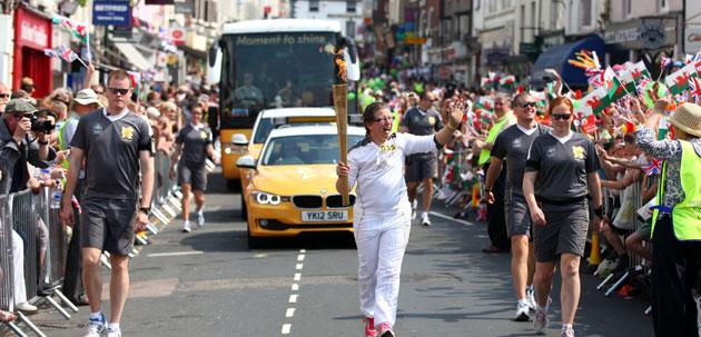 Torchbearer 035 Hazel Cave-Browne-Cave carries the Olympic Flame on the Torch Relay leg between Monmouth and Raglan
