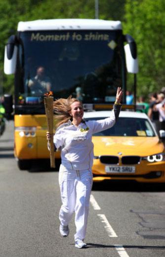 Torchbearer 068 Emma King carries the Olympic Flame on the Torch Relay leg between Blaenavon and Pontypool.